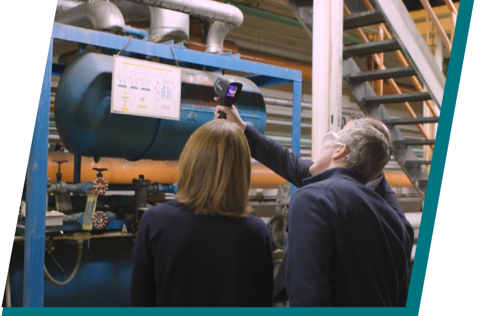 Two people inspecting industrial equipment